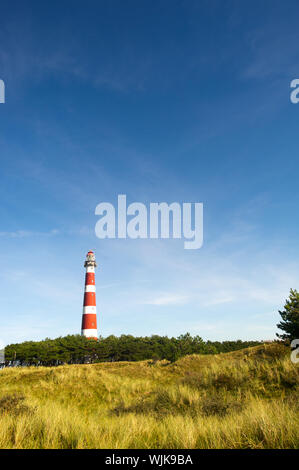 classic lighthouse in red and white at Dutch island Ameland Stock Photo