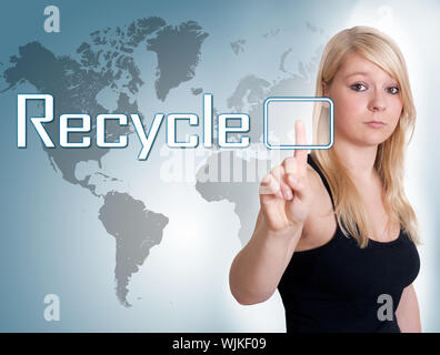 Young woman press digital Recycle button on interface in front of her Stock Photo