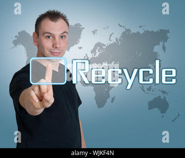 Young man press digital Recycle button on interface in front of him Stock Photo