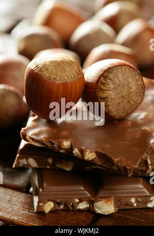 Hazelnuts and chocolate on brown wood enviroment at studio Stock Photo