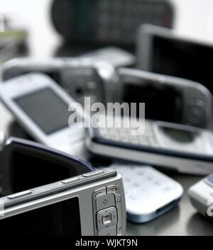 Assorted mixed mobile phones, old, new technology in cell telephones Stock Photo