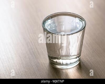 Full glass of water on the wooden table. Stock Photo