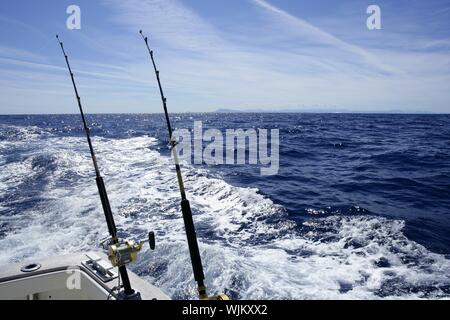 Fishing on the boat with trolling rod and reel. Blue Mediterranean
