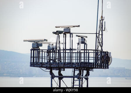 Rotating antennas of a military radio station on a tower. Stock Photo