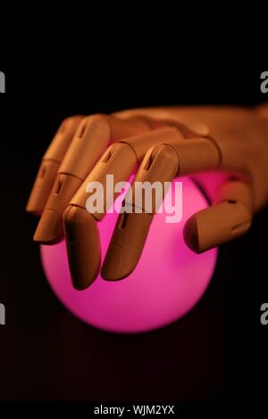 Wooden mannequin hand, ball of light, fortune teller, adivination Stock Photo