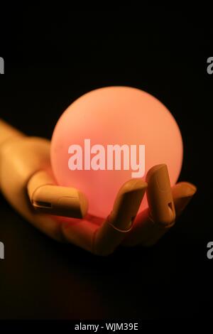 Wooden mannequin hand, ball of light, fortune teller, adivination Stock Photo