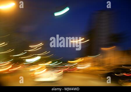 abstract blur city golden night lights, blue sky and traffic Stock Photo