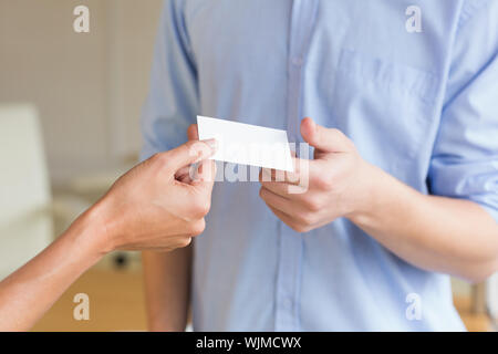 Cropped image of business people exchanging visiting cards in office Stock Photo