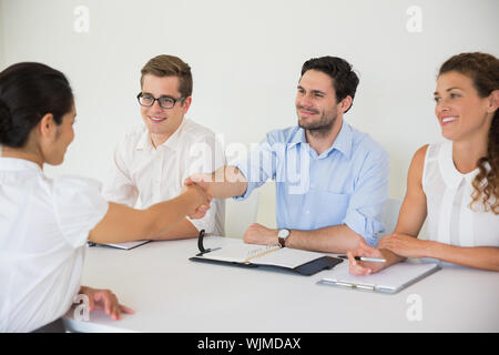 Business people shaking hands during job recruitment meeting in office Stock Photo