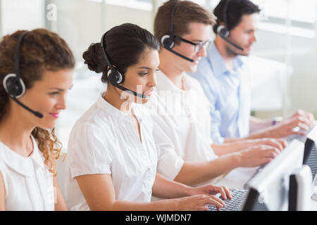 Customer service operators working at desk in office Stock Photo