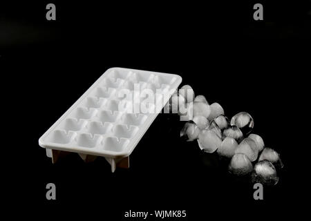 Ice cubes removed from the ice cube. Black background. Stock Photo