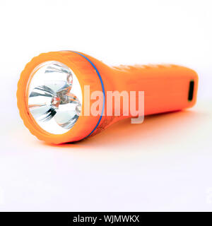 used orange flashlight isolated on white background Stock Photo