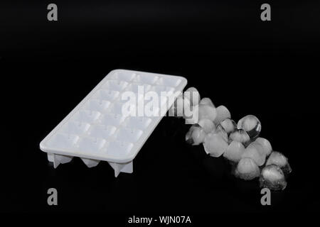 Ice cube removed from the refrigerator. Black Background Stock Photo