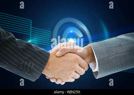 Composite image of business handshake against shiny copyright icon on black background Stock Photo