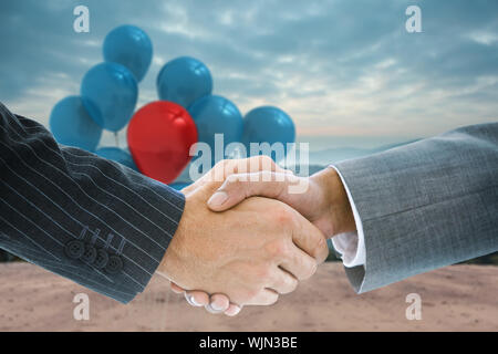 Composite image of business handshake against technological background with hexagons Stock Photo