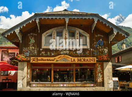 Exterior of a bar restaurant in the centre of Chamonix-Mont-Blanc in typical Savoyard architectural style in a sunny summer day, Haute Savoie, France Stock Photo