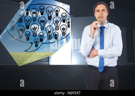 Thinking businessman biting glasses against door opening revealing light Stock Photo