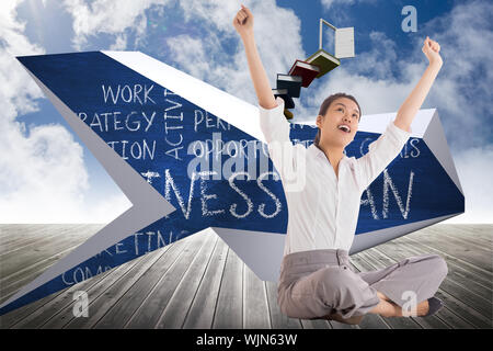 Businesswoman sitting cross legged cheering against book steps leading to door on sky Stock Photo