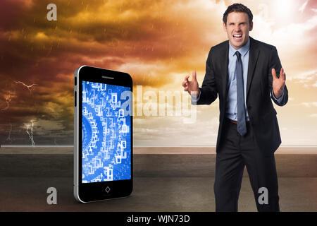 Stressed businessman gesturing against balcony and stormy sky Stock Photo