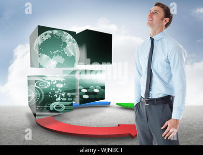 Smiling businessman standing with hand in pocket against blue red and green arrows in desert landscape Stock Photo