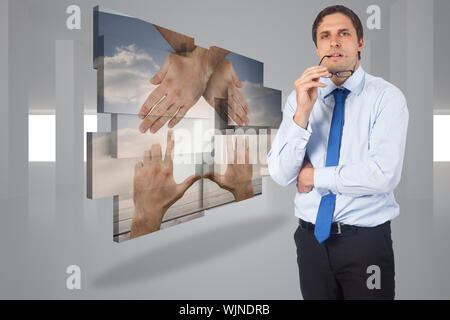 Thinking businessman biting glasses against digitally generated room Stock Photo