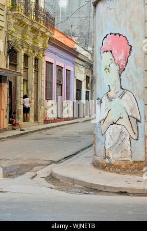 Street photography in Central Havana- Wall mural painted on colonial architecture on Calle Neptuno , La Habana (Havana), Habana, Cuba Stock Photo