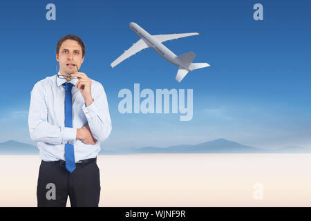 Thinking businessman biting glasses against serene landscape Stock Photo