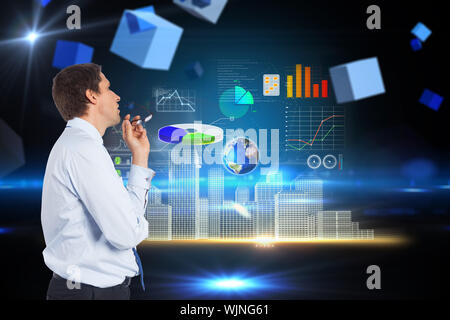 Thinking businessman biting glasses against boxes on technical background Stock Photo