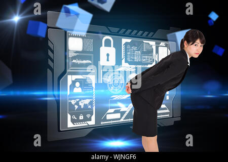 Serious businesswoman bending against boxes on technical background Stock Photo