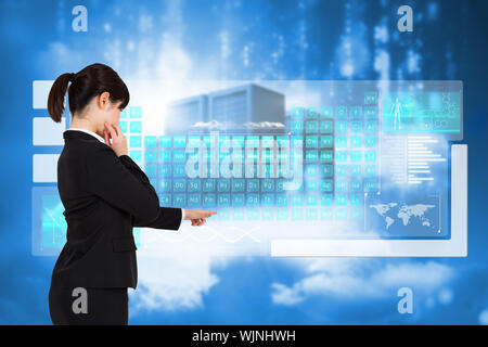 Businesswoman pointing against cityscape on cloud Stock Photo