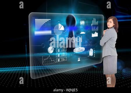 Focused businesswoman against keyhole on technological background Stock Photo