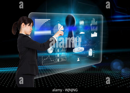 Serious businesswoman pointing against keyhole on technological background Stock Photo
