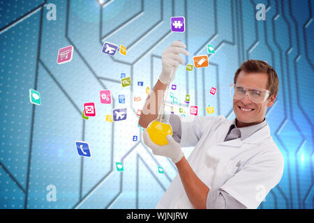 Young scientist working with a beaker against circuit board on futuristic background Stock Photo