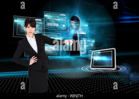 Businesswoman pointing against keyhole on technological background Stock Photo