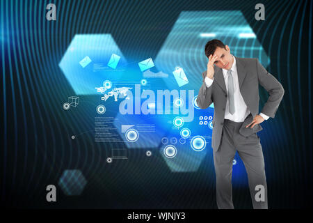 Tired businessman against shiny hexagons on black background Stock Photo