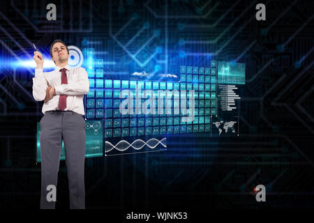 Thinking businessman holding pen against futuristic black and blue background Stock Photo