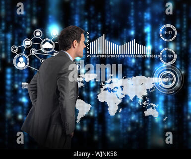 Smiling businessman with hands on hips against lines of blue blurred letters falling Stock Photo