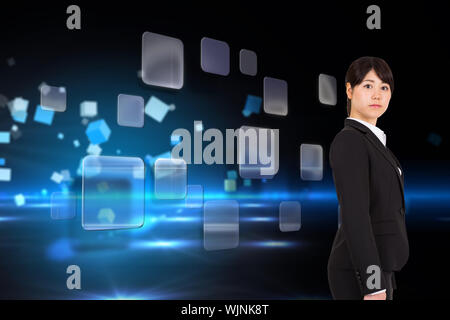 Serious businesswoman against boxes on technical background Stock Photo