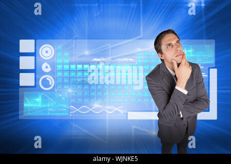 Thinking businessman touching his chin against glowing background with squares Stock Photo