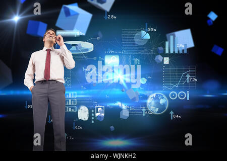 Thinking businessman holding glasses against boxes on technical background Stock Photo