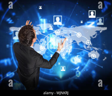 Stressed businessman gesturing against blue background with letters Stock Photo