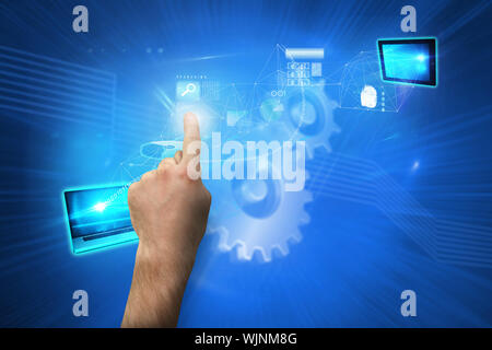 Hand pointing against shiny cogs on blue background Stock Photo