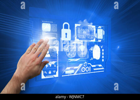 Hand presenting against shiny cogs on blue background Stock Photo