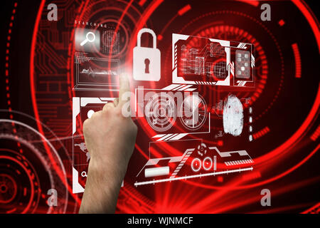 Hand pointing against shiny red circles on black background Stock Photo