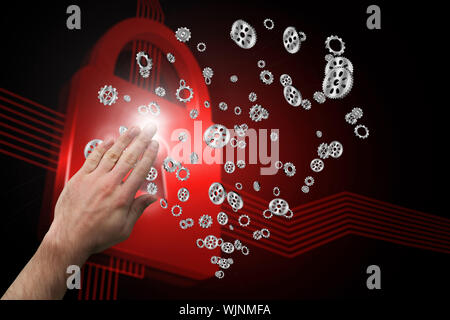 Hand presenting against shiny red lock on black background Stock Photo