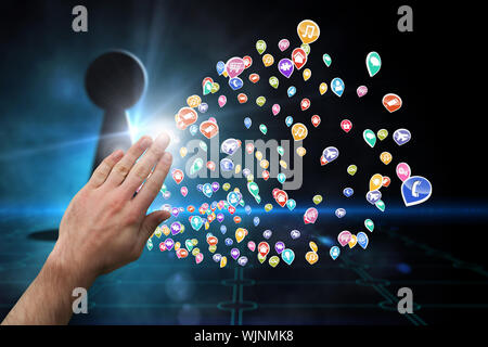 Hand presenting against keyhole on technological black background Stock Photo