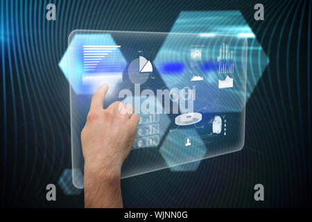 Hand pointing against shiny hexagons on black background Stock Photo