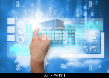 Hand pointing against cityscape on cloud Stock Photo
