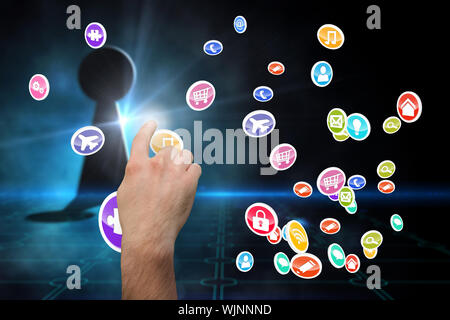 Hand pointing against keyhole on technological black background Stock Photo
