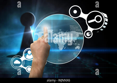 Hand pointing against keyhole on technological black background Stock Photo